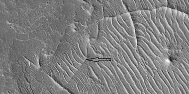 Close view of ridge networks, as seen by HiRISE under HiWish program.  Arrow points to small, straight ridge.