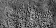 Closer view of ejecta, as seen by HiRISE under HiWish program.  Note:  Arrows show examples of boulders sitting in pits.