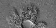 Close view of ejecta of pedestal crater, as seen by HiRISE under HiWish program.  Arrow shows one of example of a boulder sitting in a pit.  This image will be enlarged to better show this in the next two images.