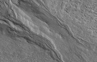 Close view of gullies, as seen by HiRISE under HiWish program.  Streamlined features are visible in gully channels.