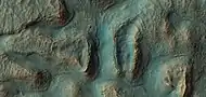 Close, color view of crater ejecta, as seen by HiRISE under HiWish program. Benches around mounds my mark a former water level.  The hot ejecta may have melted ice in the ground forming small channels.