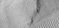 Grooves on wall of Kasei Valles, as seen by HiRISE under HiWish program. Grooves may be caused by water moving in the channel.