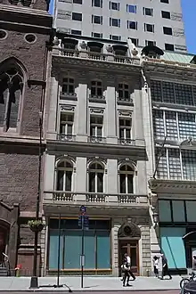 The five-story facade of the previous building with the address 712 Fifth Avenue, as seen from across the street