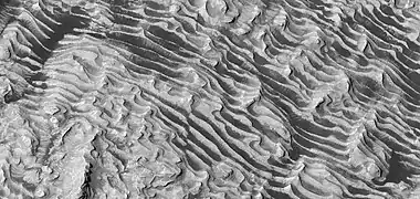 Close view of layers on floor, as seen by HiRISE. Some faults are visible in image.