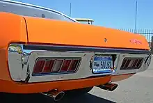 1971 GTX tail light panel with factory slotted exhaust tips