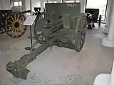 An Ehrhardt 7.5 cm Model 1901 with pole trail, spoked wooden wheels, gun shield and recoil spade.  This is a typical WWI era, horse-drawn, direct fire, field gun.