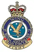 Military crest for 78 Wing, Royal Australian Air Force, with eagle carrying sword in front of Southern Cross constellation; the motto reads "Fight"