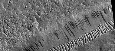 Wide view of dark slope streaks on wall of trough.