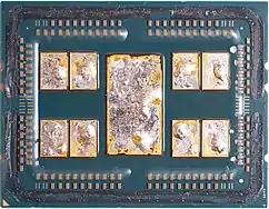 A delidded AMD 7702 featuring 8 CCDs and 1 I/O die, with remains of the solder thermal interface material (TIM) on the chiplets.