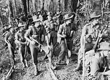 Troops of the 2/16th Battalion, watch aircraft bombarding The Pimple prior to their attack on Japanese positions there,  27 December 1943.