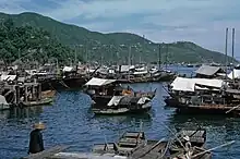 Boats in a harbor with hills in the background