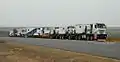 TII Nicolas Tractomas ballast tractors pulling a hydraulic modular trailer with girder bridge.