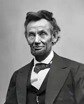 An older, tired-looking Abraham Lincoln with a beard.