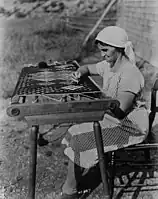 An Acadian lady making a rug, 1938