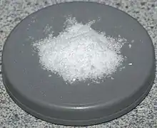 Some white powder on a round gray platform.