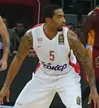 Acie Law wearing the golden-badged back-to-back European Champions 2012–2013 Olympiacos jersey