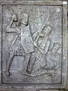 War scene of the Tropaeum Traiani: a Roman legionary fighting with a Dacian warrior, while a Buri warrior, who has a Suebian knot, is wounded on the ground.