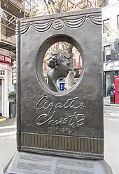 Colour photograph of a large, book-shaped bronze memorial