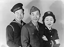 From left to right, a Sailor, a Soldier, and a navy officer take a group photograph.