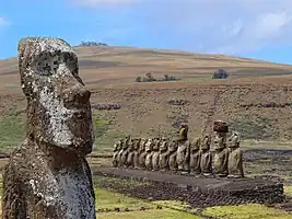 Ahu Tongariki with volcano Poike in the background and the nearby "Traveling Moai" in the foreground.