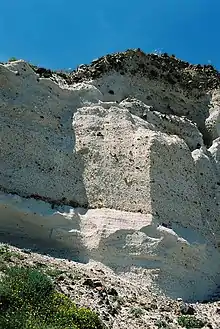 Photograph of the side of a cliff, showing layers of volcanic rock