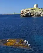 Martello tower, Alcaufar with Illa de l'aire lighthouse in the distance.