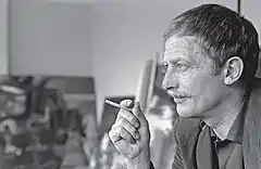 Black and white photograph of Alejandro Obregón in profile smoking a cigarette.