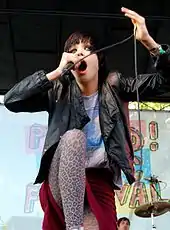 Colour photograph of Alice Glass performing live in 2008