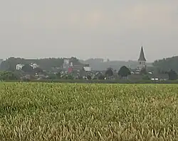 Brewery of Alken (left) and St-Aldegondis Church (right)