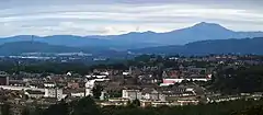 A town landscape with hills in the background.