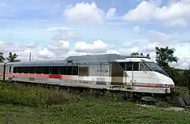 A passenger trainset with a geometric red, white, and black color scheme