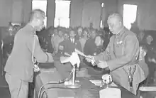 Chen Yi (right) accepting the receipt of Order No. 1 signed by Rikichi Andō (left), the last Japanese Governor-General of Taiwan, in Taipei City Hall