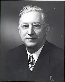 Portrait photo of Andrew B. Turnbull wearing a suit and tie