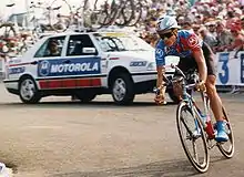 A cyclist riding a bike while preparing to round a corner.