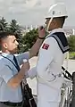 Assistant removes perspiration from a guard at Anıtkabir