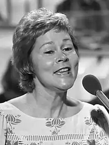 Black-and-white picture of Anita Kerr singing into a microphone.