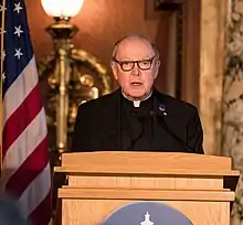 Leo J. O'Donovan at a podium in the Dutch Embassy, Washington, D.C.