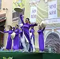 Female students wearing purple ao dai are dancing, January 2009