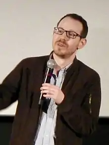 Ari Aster speaking into a microphone.