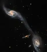 This image from the NASA/ESA Hubble Space Telescope shows two of the galaxies in the galactic triplet Arp 248.