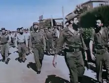 Camilo Cienfuegos walking in front of Huber Matos, who has been arrested but not handcuffed