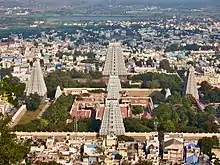 Set of temple towers with urban centre and hill range in the background