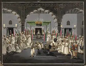 An Imam reads verses from the Quran after Isha' (night prayers) in the Mughal Empire