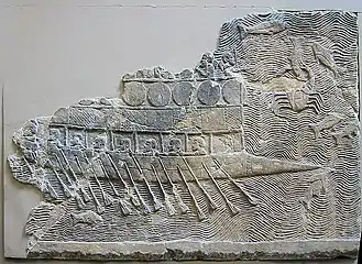 WA 124772: An Assyrian warship carved into stone (700–692 BC) from the reign of Sennacherib. Nineveh, South-West Palace, Room VII, Panel 11. British Museum.