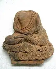 Tile with seated Buddha