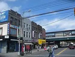 Avenue U at East 15th Street, in the rapidly developing Avenue U Chinatown. The Brighton Line station is in the background.