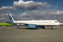 A twin-engined airliner parked at an airport