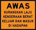 Caution heavy vehicles entering and exiting construction zone ahead