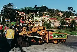 Asphalt pavers can be on wheels or tracks.  Here is a small Blaw Knox wheel type paver on a residential street job.