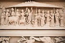 Exterior carving depicting Krishna lifting Mount Govardhan as narrated in the Shrimad Bhagavat Purana